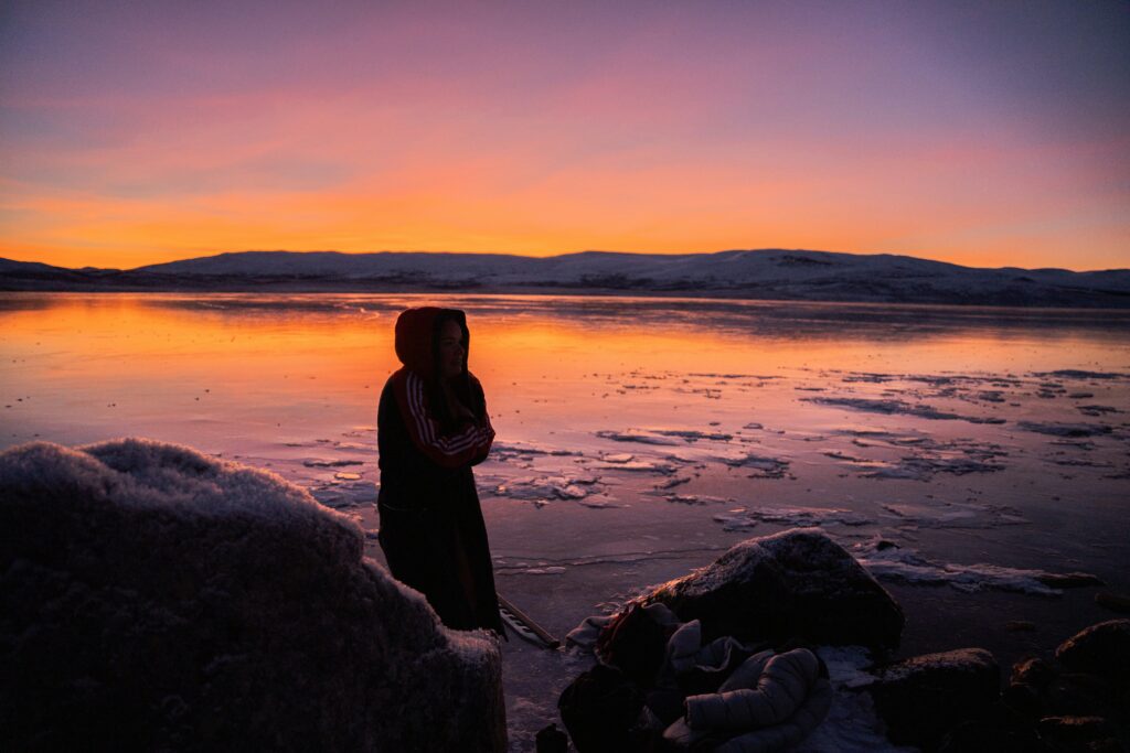 Woman cold water swimming at sunset