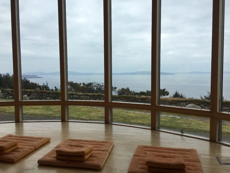 meditation center with yoga mats looking out at the ocean