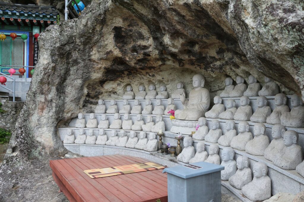 lots of buddha statues at a meditation center