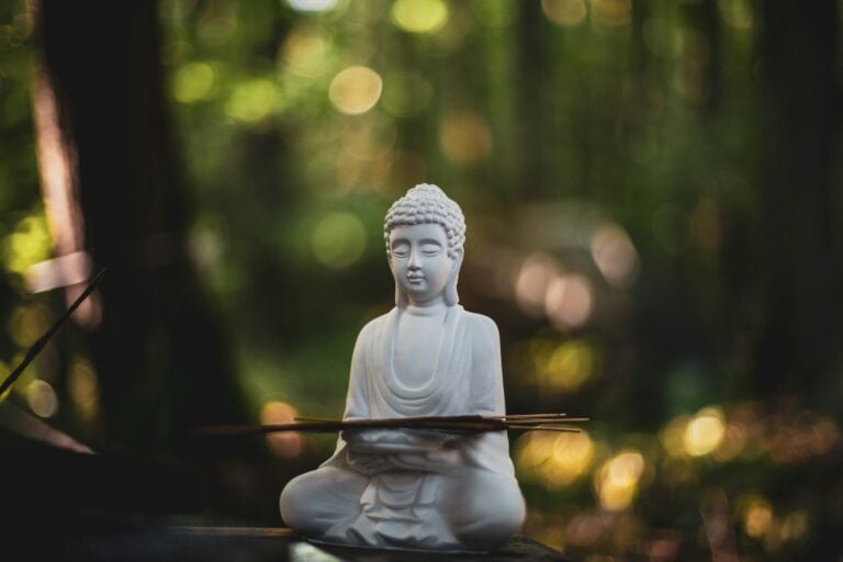 A buddha statue in nature practicing Breathwork for overwhelm